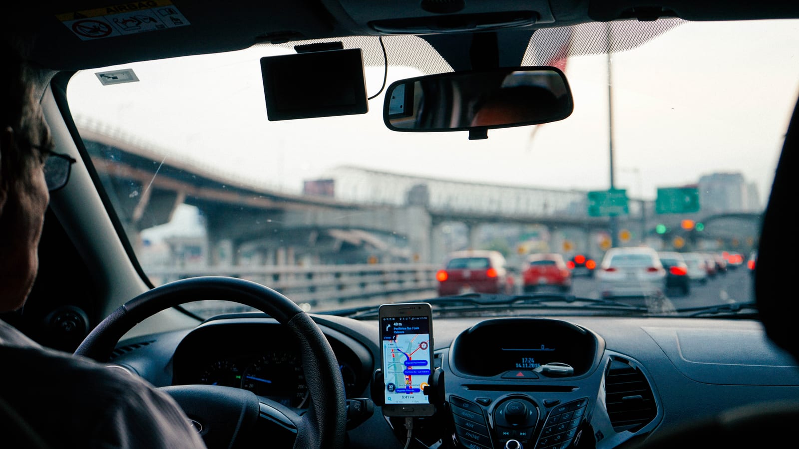 An Uber driver driving his passengers in London