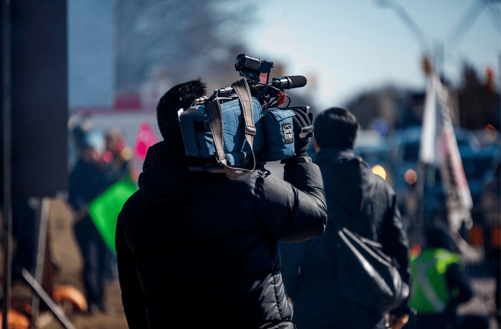 A field journalist reporting on location during a protest